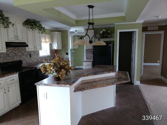 139 Roy Bryant Road Cochran, GA 31014 - Photo 2 of 14 a kitchen with a sink and a stove top oven