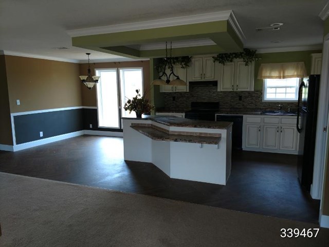 139 Roy Bryant Road Cochran, GA 31014 - Photo 14 of 14 a kitchen with stainless steel appliances granite countertop a stove a sink and a microwave