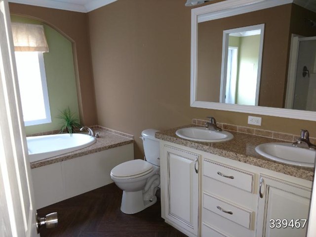 139 Roy Bryant Road Cochran, GA 31014 - Photo 8 of 14 a bathroom with a granite countertop sink toilet and mirror