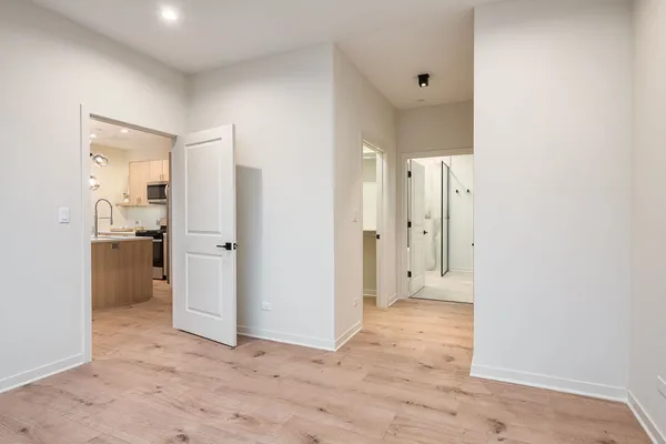 a view of a hallway with wooden shelves