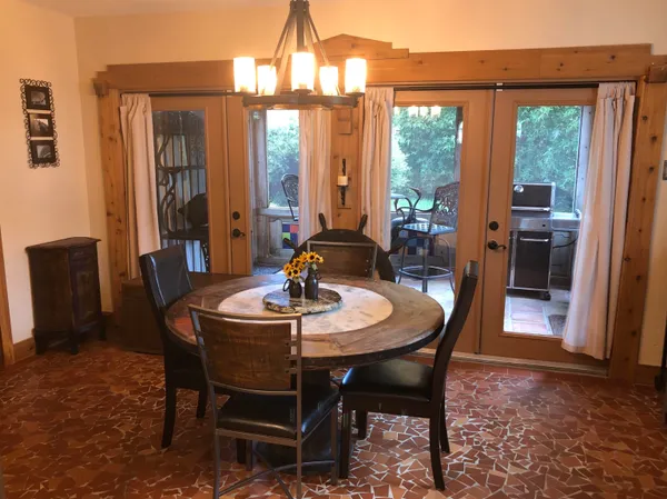 a dining room with furniture a chandelier and window