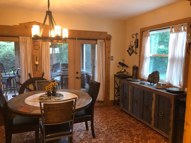 a dining room with furniture and window