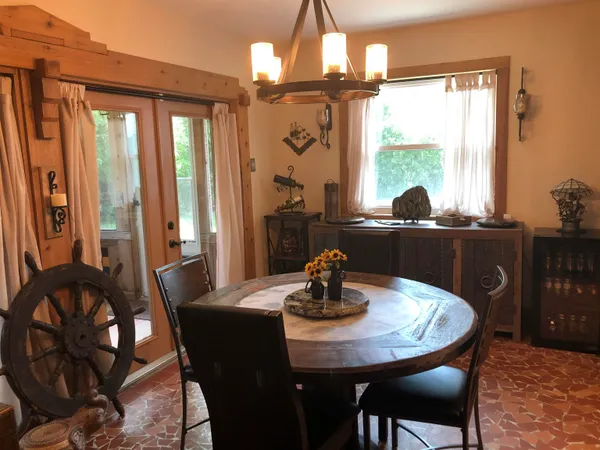 a dining room with furniture and window