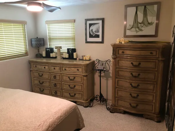 a bedroom with a bed and a dresser