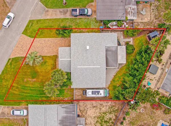 an aerial view of a house with a yard and garden
