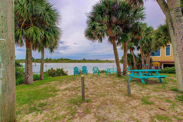 a view of a lake with a table and chairs
