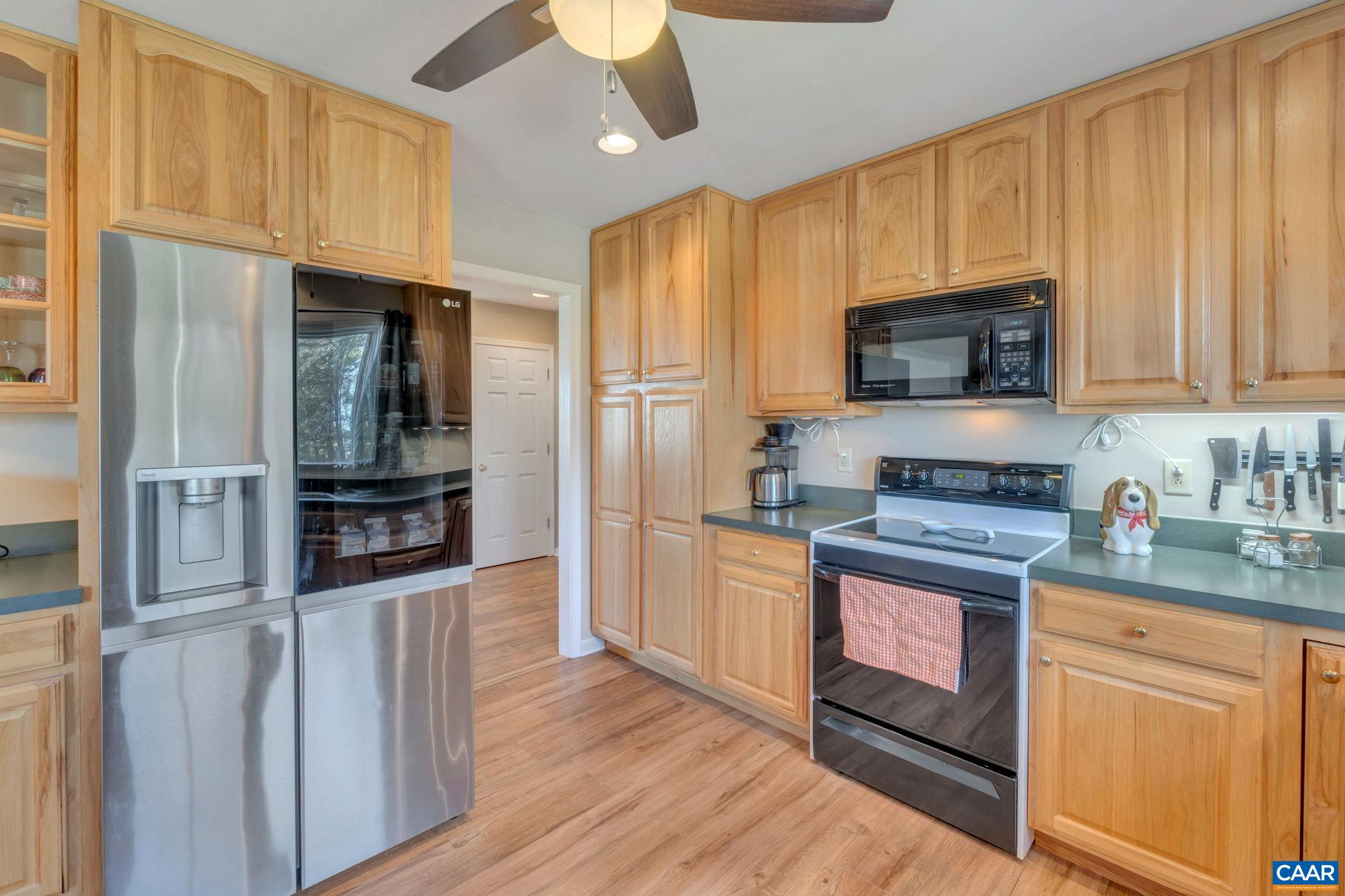 5905 Venable Road Kents Store, VA 23084 - Photo 8 of 37 a kitchen with stainless steel appliances granite countertop a refrigerator microwave and stove top oven