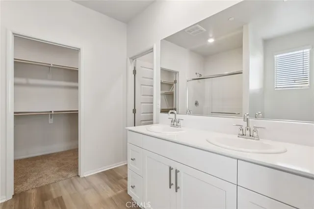 a bathroom with a sink double vanity and a mirror