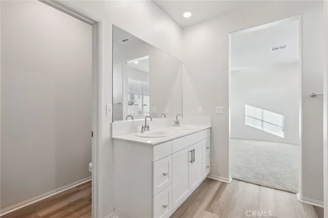 a bathroom with a double vanity sink and mirror