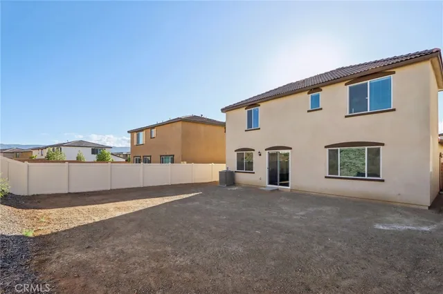 a view of a house with a big yard and large tree