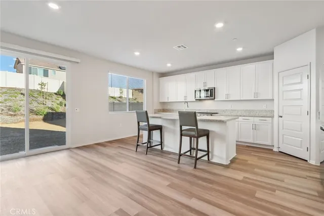a view of kitchen with granite countertop cabinets and outdoor view