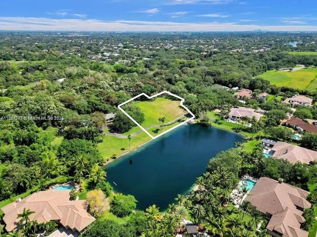 an aerial view of a house with a lake view