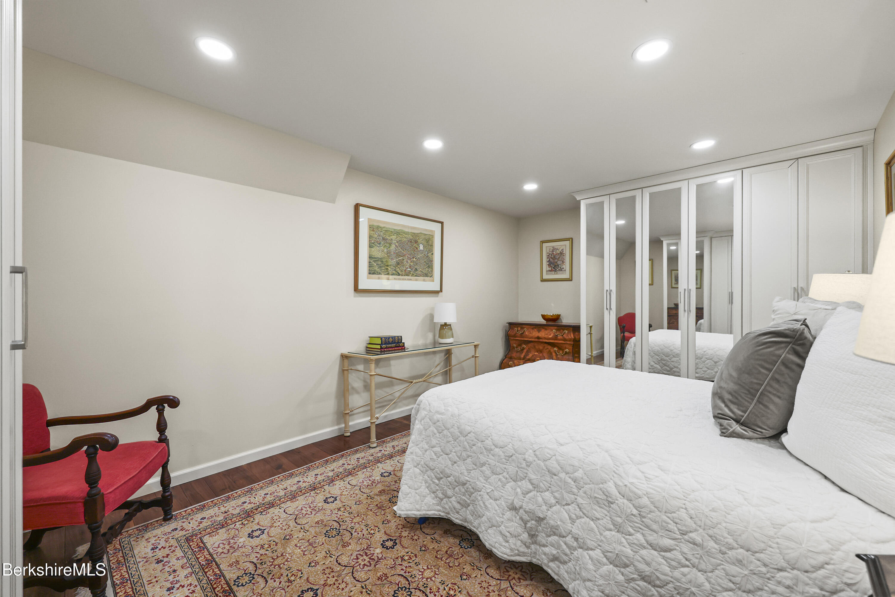 60 Old Cheshire Road Lanesborough, MA 01237 - Photo 50 of 81 a bedroom with a bed a lamp and a large mirror