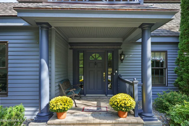 a living room with furniture and a book shelf