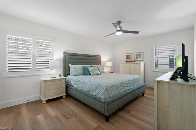 a dining hall with stainless steel appliances kitchen island granite countertop a table chairs sink refrigerator and microwave