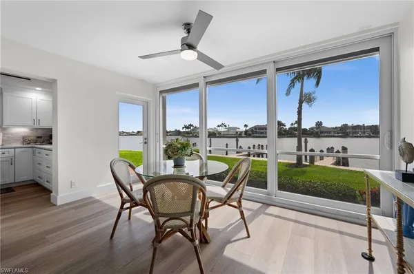 a living room with furniture kitchen view and a window