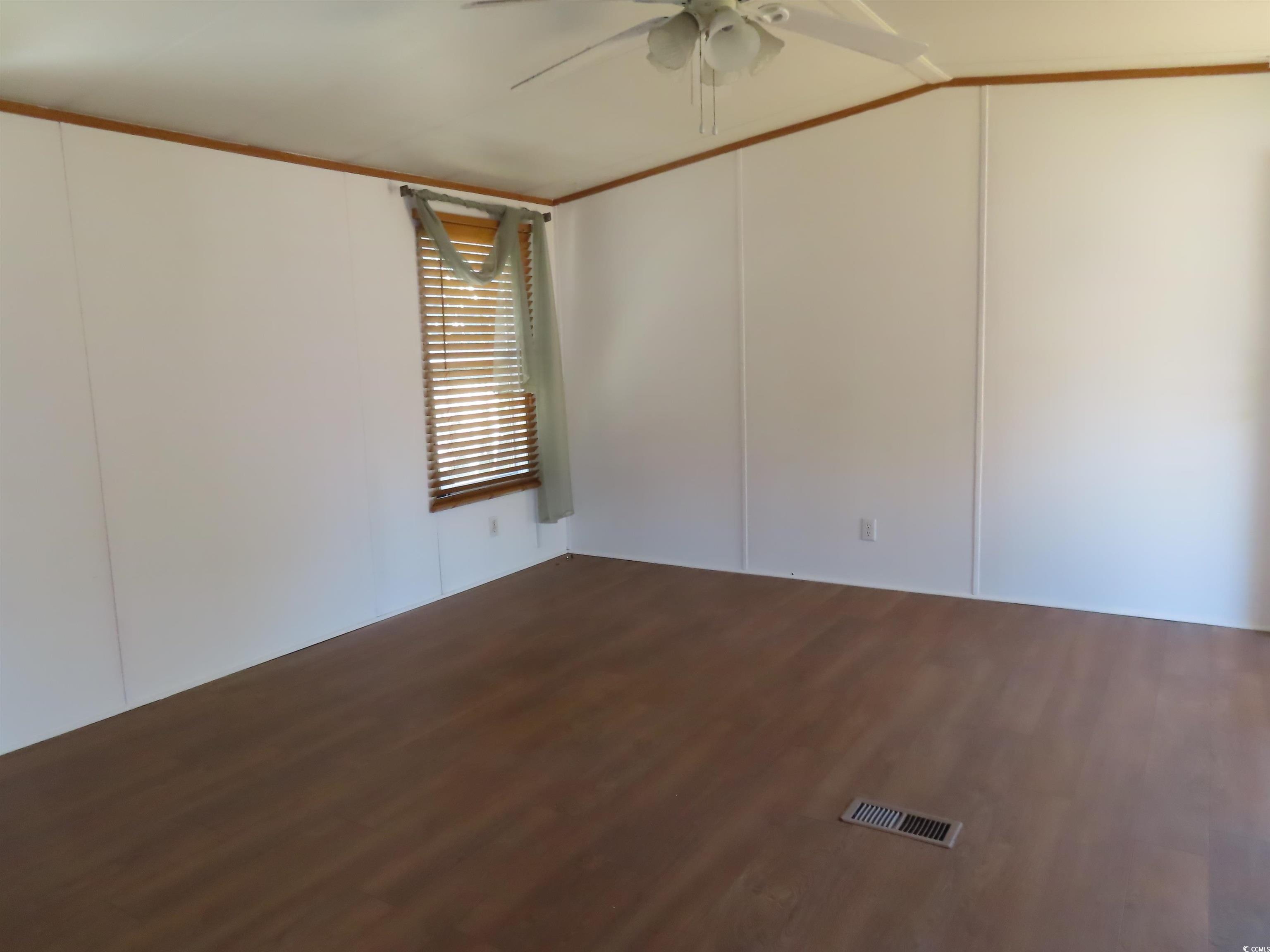 9323 Shoveler Drive Murrells Inlet, SC 29576 - Photo 14 of 23 Spare room with wood finished floors, a ceiling fan, and visible vents