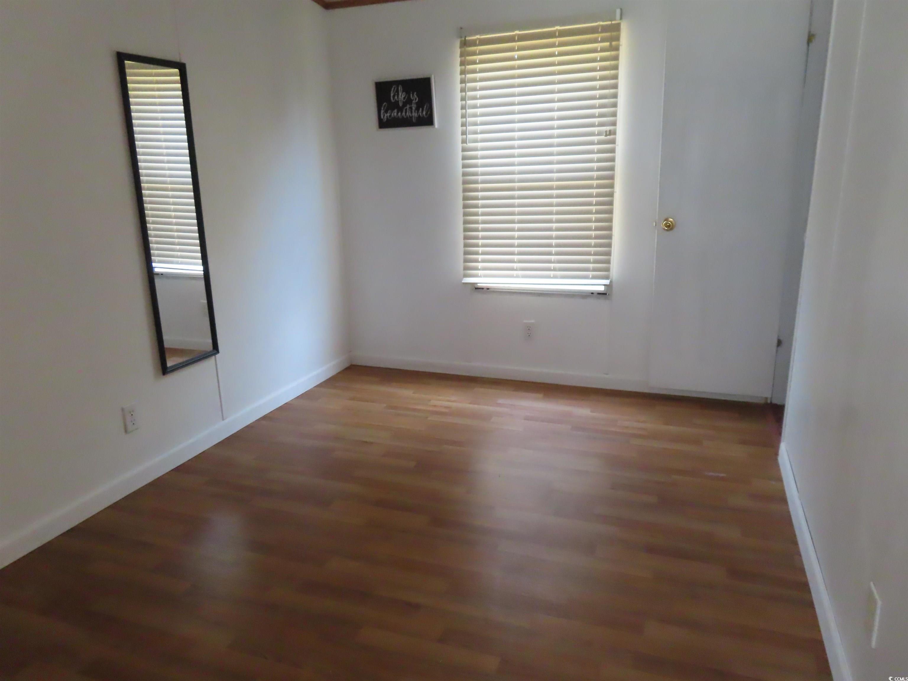 9323 Shoveler Drive Murrells Inlet, SC 29576 - Photo 15 of 23 Spare room with baseboards and wood finished floors