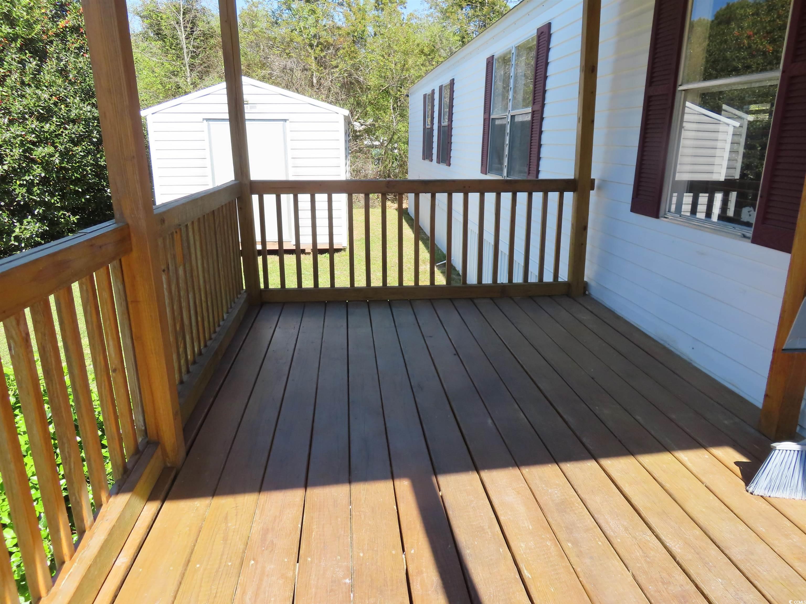 9323 Shoveler Drive Murrells Inlet, SC 29576 - Photo 4 of 23 Deck with an outdoor structure and a storage unit