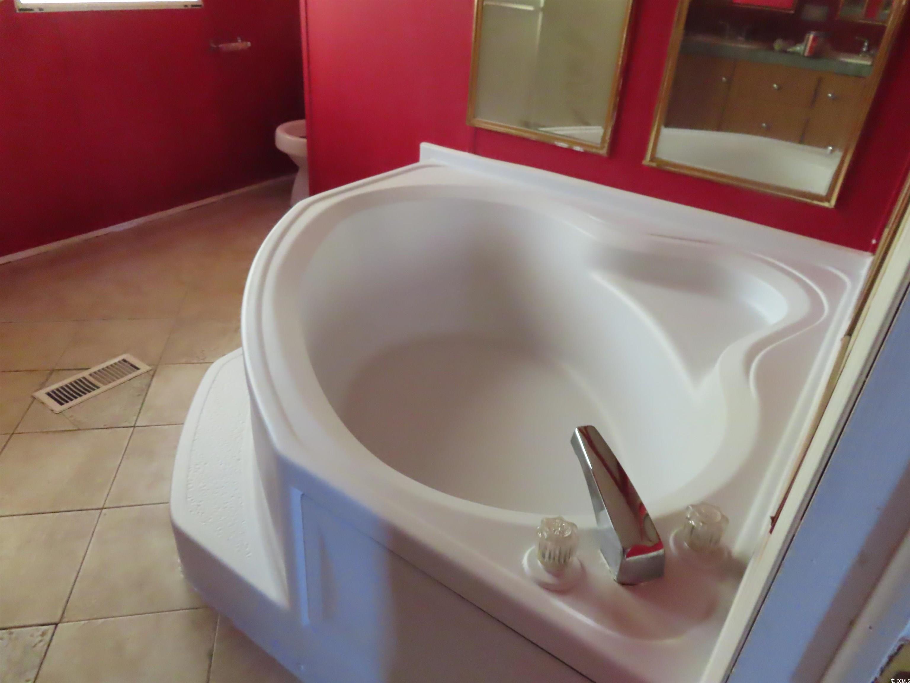 9323 Shoveler Drive Murrells Inlet, SC 29576 - Photo 6 of 23 Interior details with visible vents, a tub, and toilet
