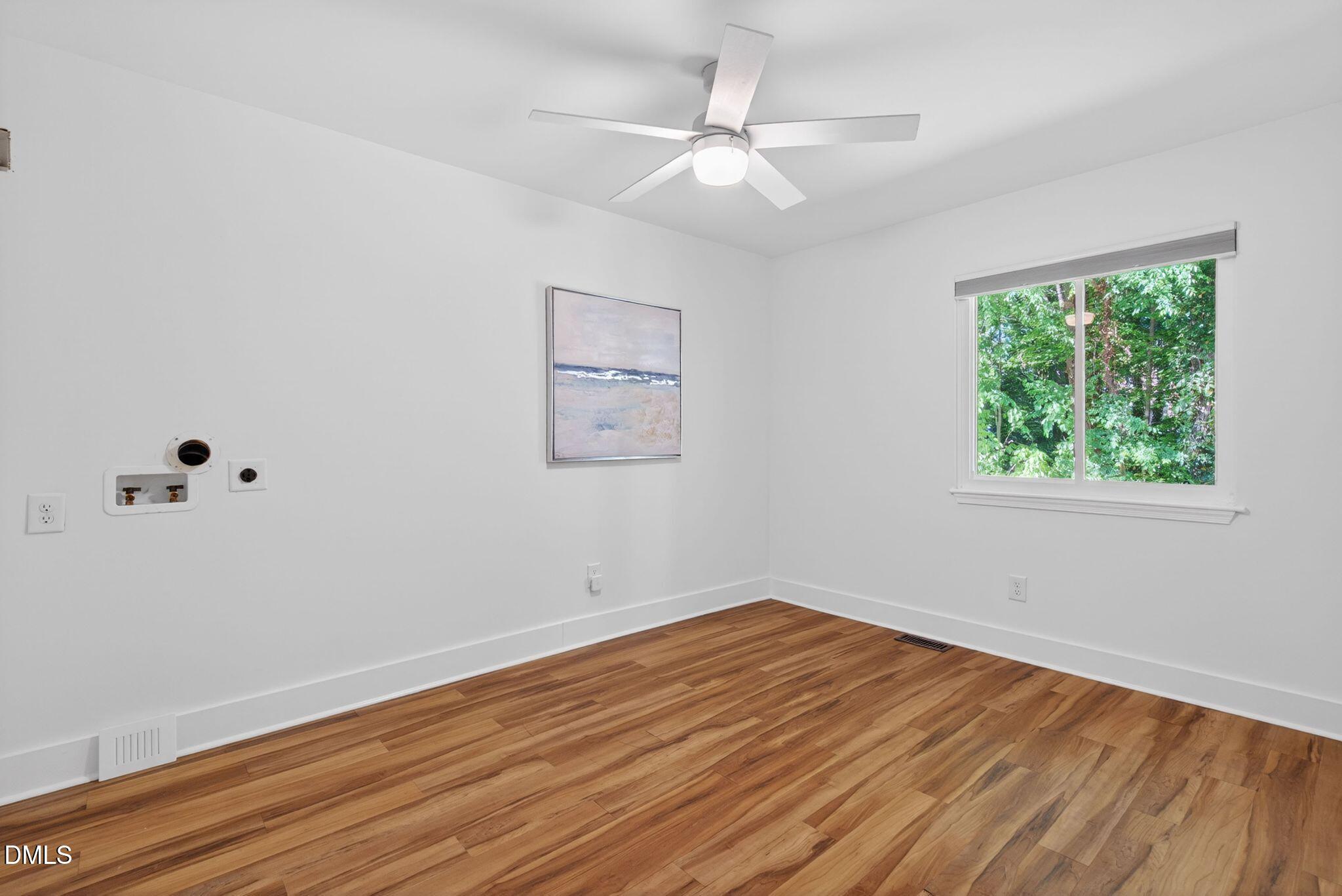 7149 Sandy Creek Drive Raleigh, NC 27615 - Photo 19 of 23 a view of a room with wooden floor and window