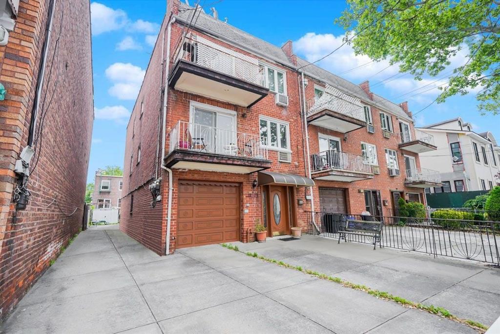a front view of a building with a garden