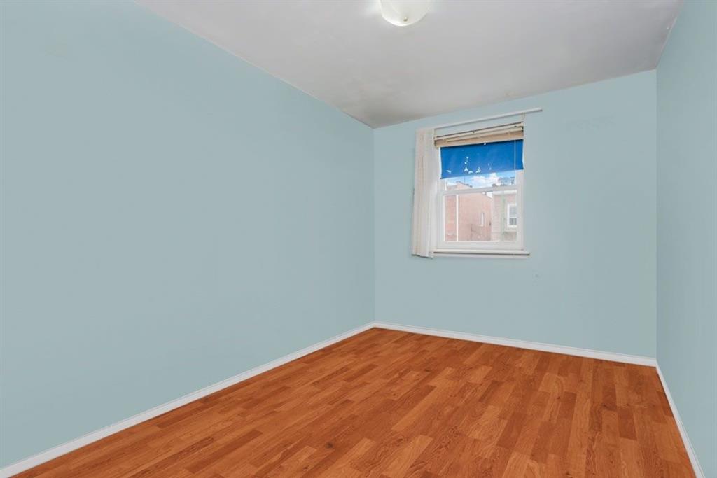 2329 West Street Brooklyn, NY 11223 - Photo 17 of 26 a view of empty room with wooden floor
