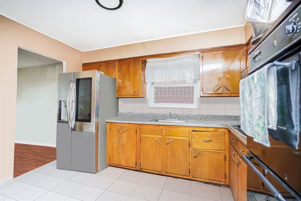 2329 West Street Brooklyn, NY 11223 - Photo 19 of 26 a kitchen with stainless steel appliances granite countertop a refrigerator and a sink