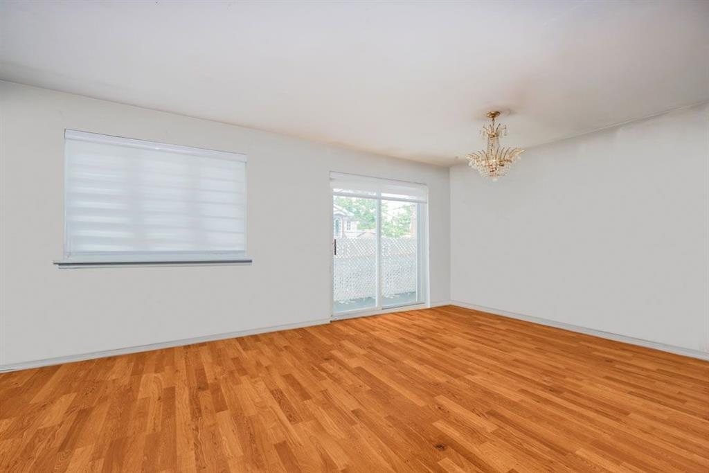 2329 West Street Brooklyn, NY 11223 - Photo 20 of 26 a view of empty room with wooden floor and fan