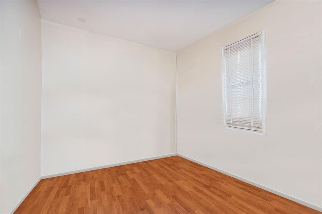 2329 West Street Brooklyn, NY 11223 - Photo 24 of 26 a view of an empty room with wooden floor and a window