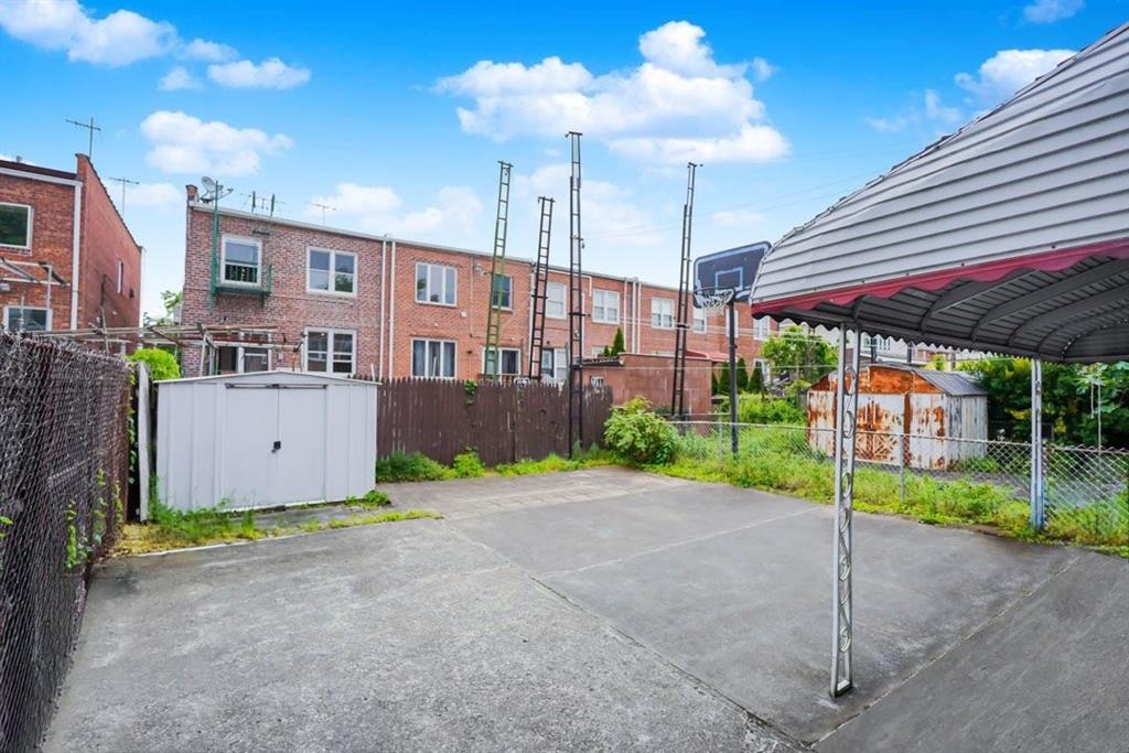 2329 West Street Brooklyn, NY 11223 - Photo 26 of 26 a yellow and red umbrella in front of house