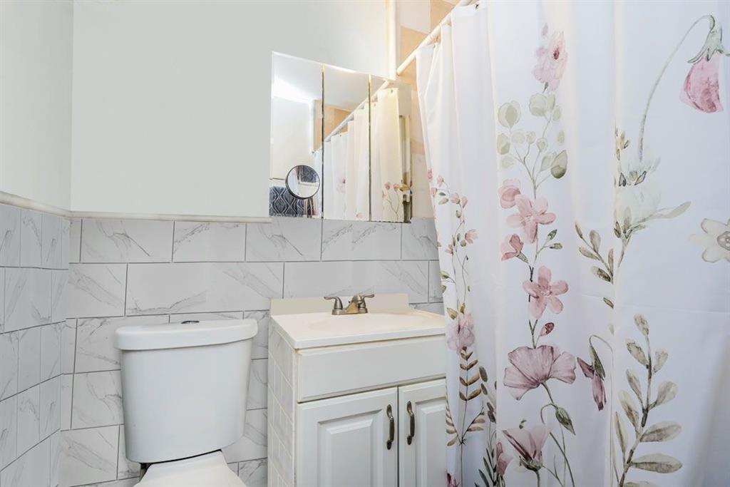 2329 West Street Brooklyn, NY 11223 - Photo 8 of 26 a bathroom with a sink and a washing machine