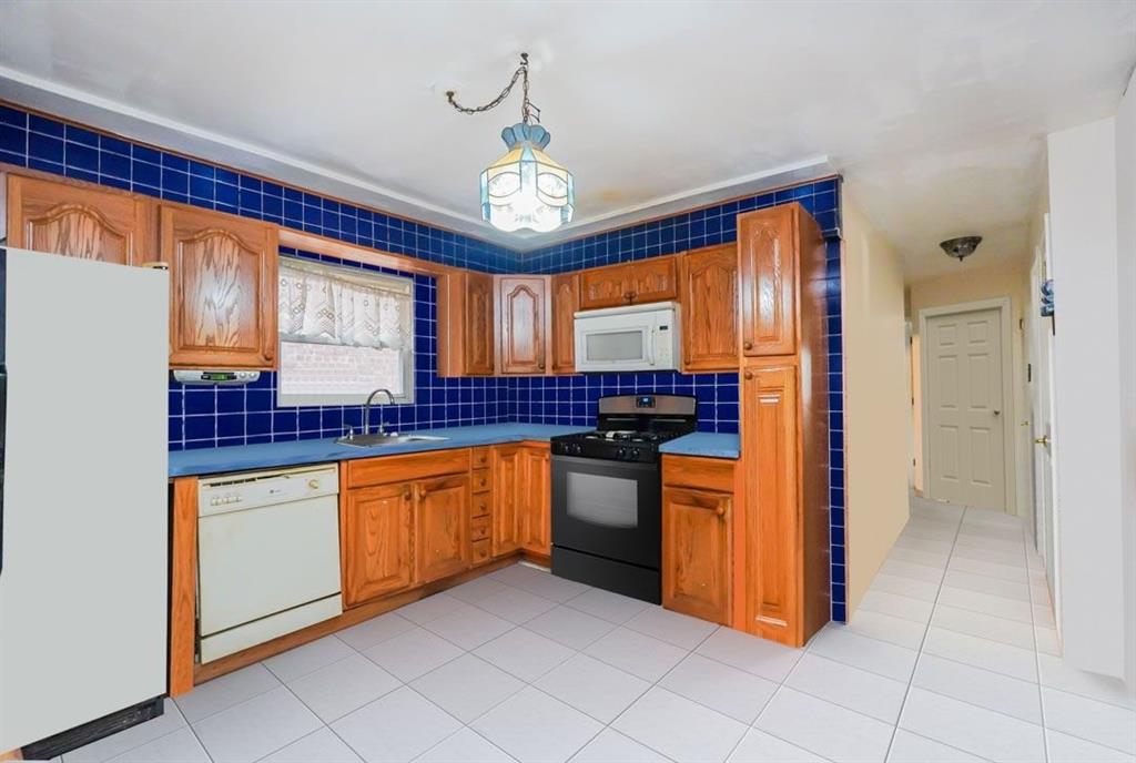 2329 West Street Brooklyn, NY 11223 - Photo 10 of 26 a kitchen with stainless steel appliances granite countertop a refrigerator and a sink