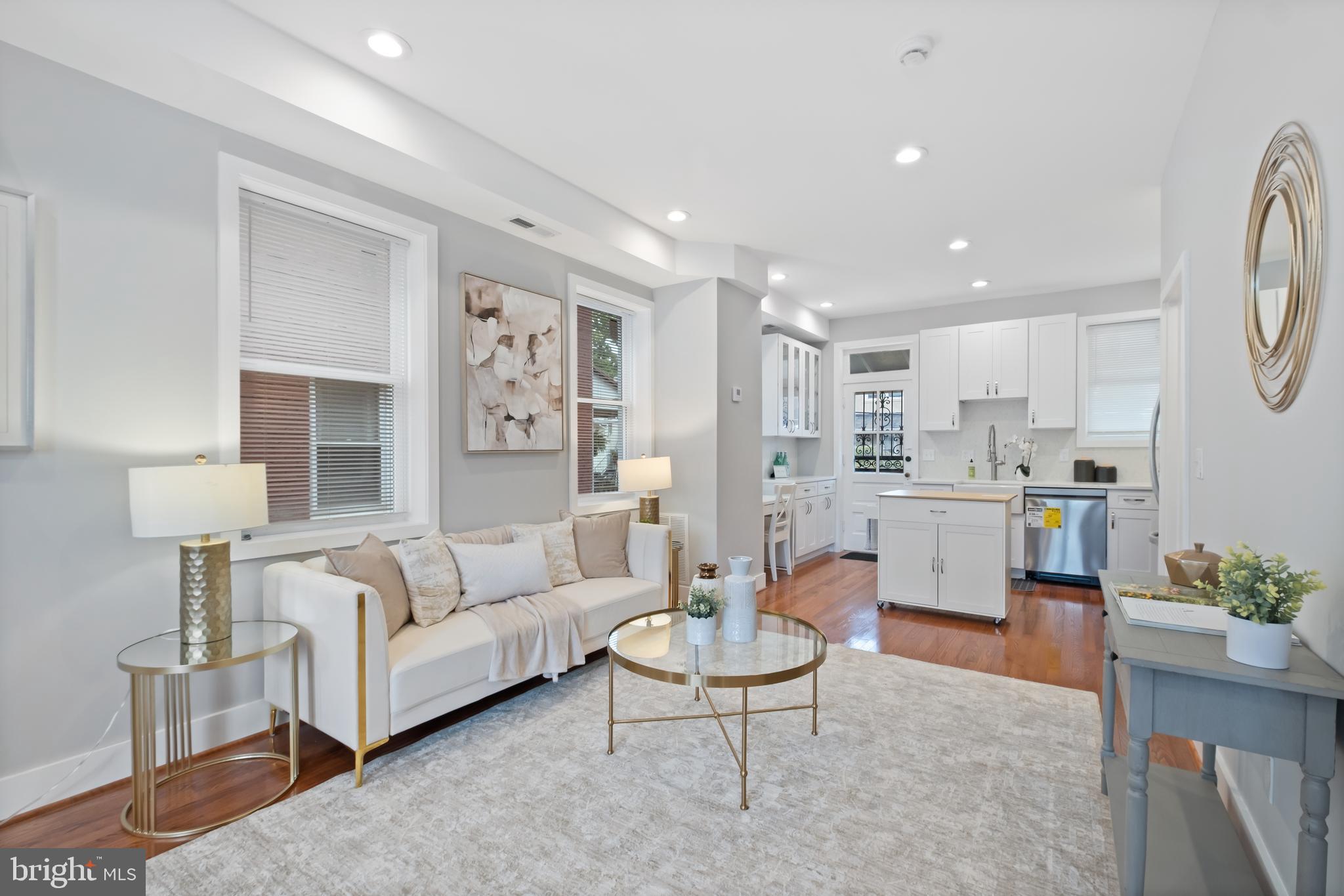 607 Tuckerman Street Northwest Washington, DC 20011 - Photo 1 of 25 a living room with furniture and a dining table with kitchen view