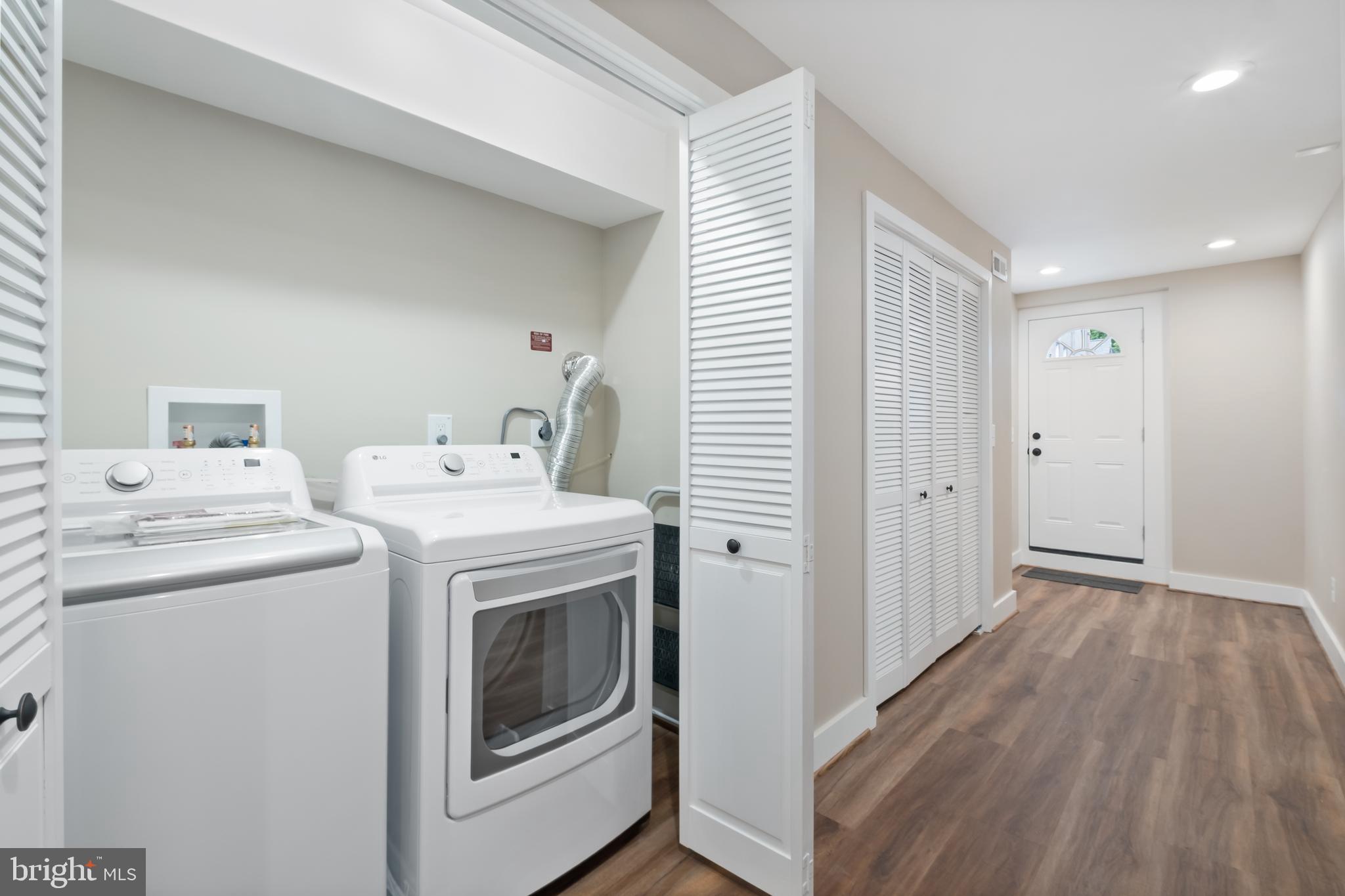 607 Tuckerman Street Northwest Washington, DC 20011 - Photo 13 of 25 a view of washer and dryer with wooden floor