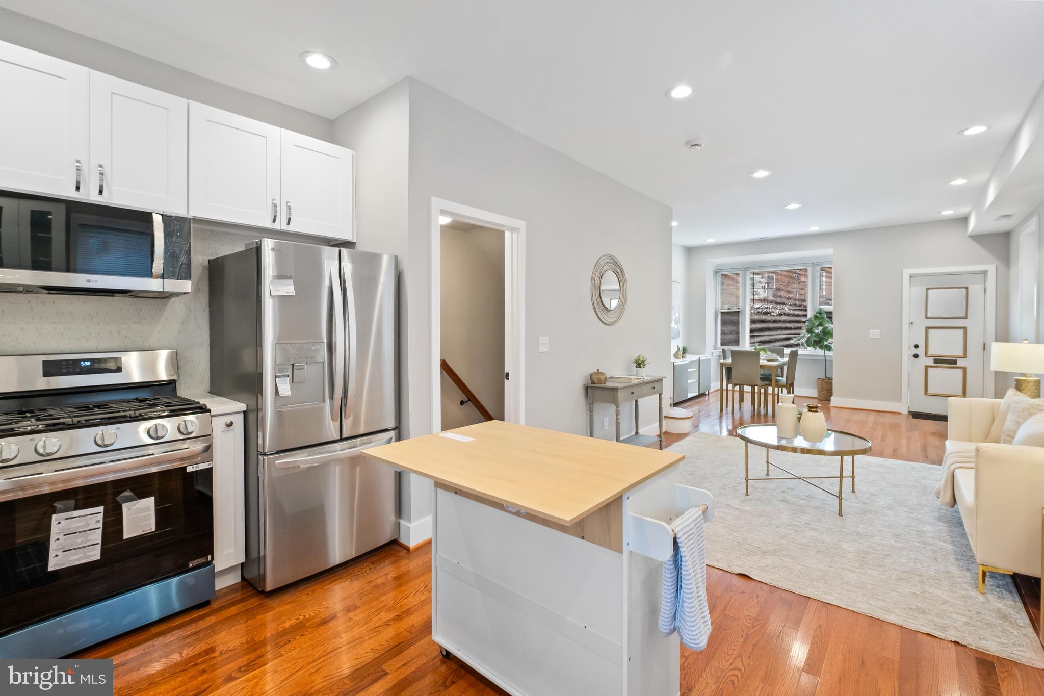 607 Tuckerman Street Northwest Washington, DC 20011 - Photo 9 of 25 a kitchen with stainless steel appliances granite countertop a refrigerator stove microwave and sink