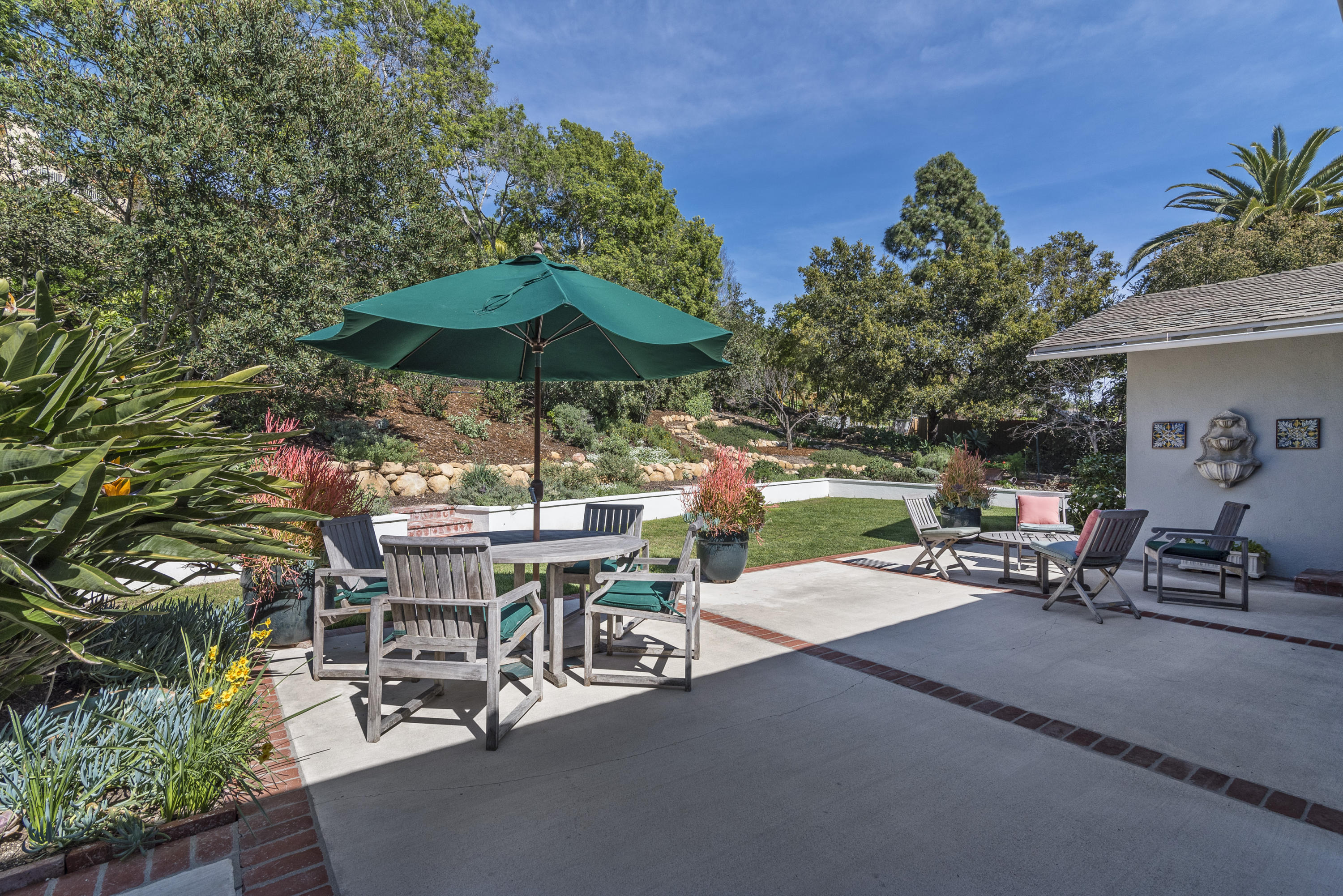 207 Alston Road Santa Barbara, CA 93108 - Photo 12 of 14 a view of a patio with a table and chairs under an umbrella
