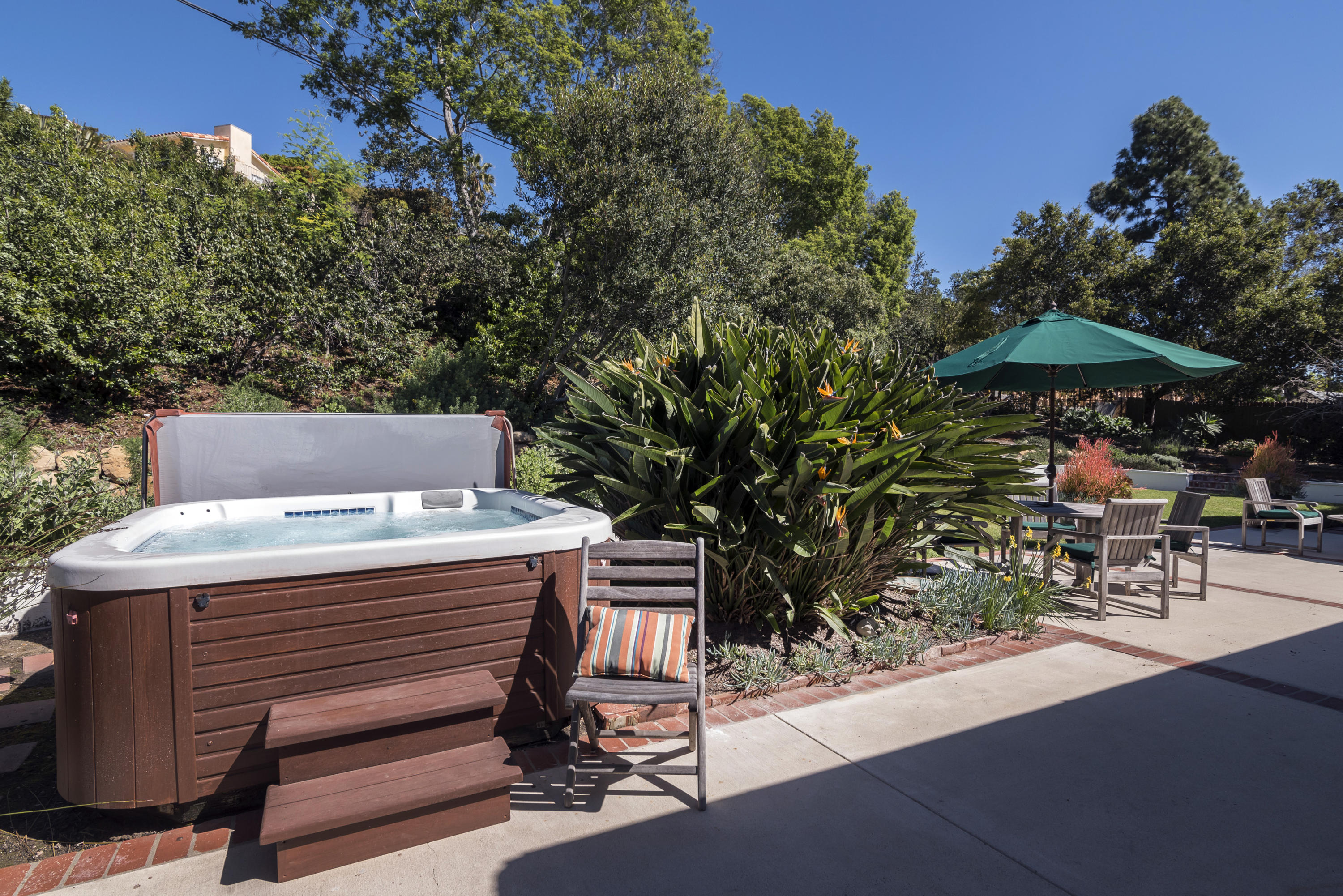 207 Alston Road Santa Barbara, CA 93108 - Photo 13 of 14 a view of a patio with table and chairs under an umbrella