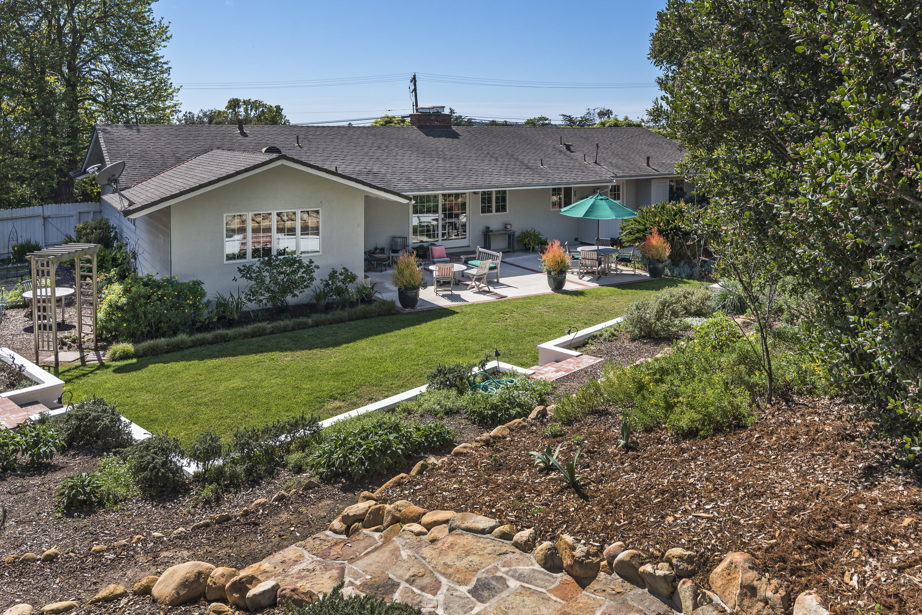 207 Alston Road Santa Barbara, CA 93108 - Photo 14 of 14 a view of a big house with table and chairs under an umbrella