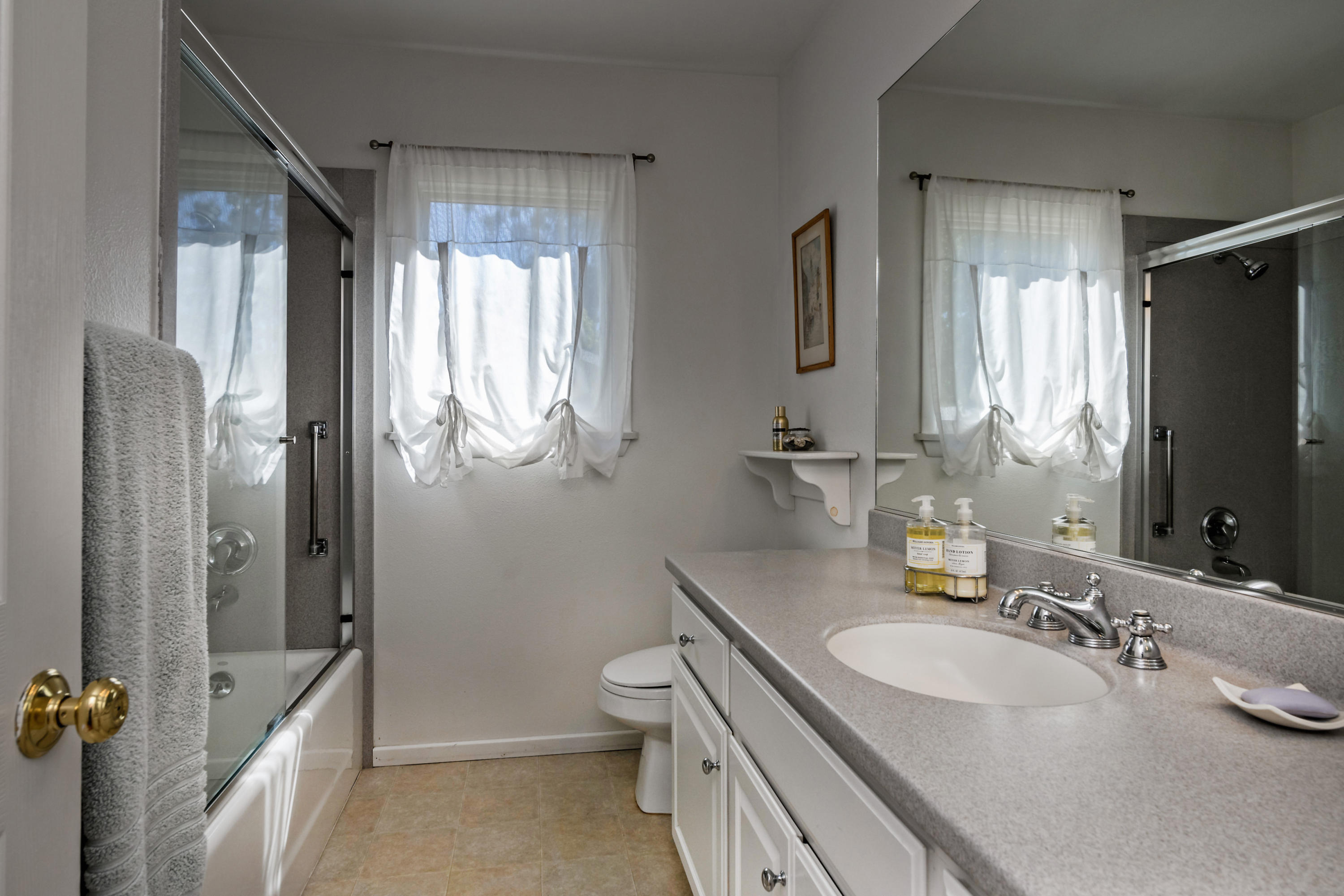 207 Alston Road Santa Barbara, CA 93108 - Photo 8 of 14 a bathroom with a granite countertop sink toilet and shower