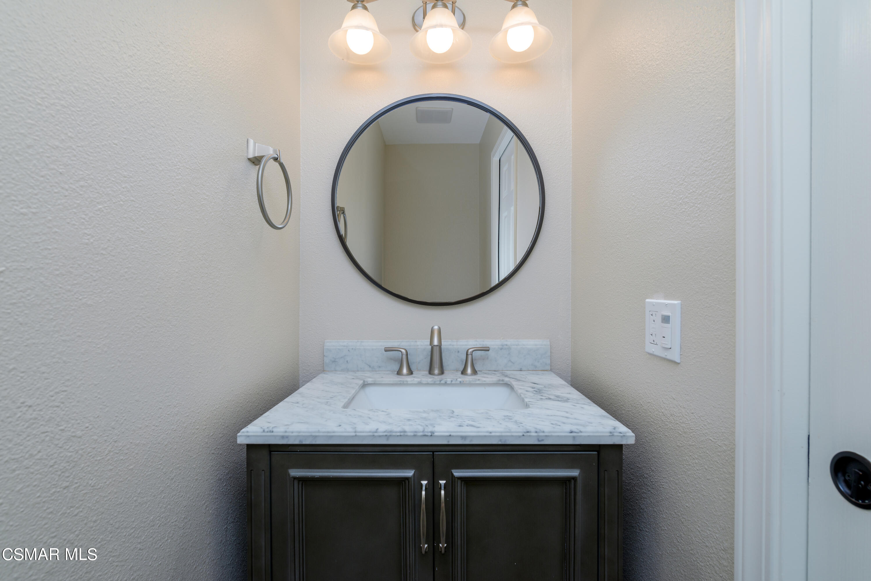 1667 Edgewater Lane Camarillo, CA 93010 - Photo 12 of 32 a bathroom with a granite countertop sink and a mirror