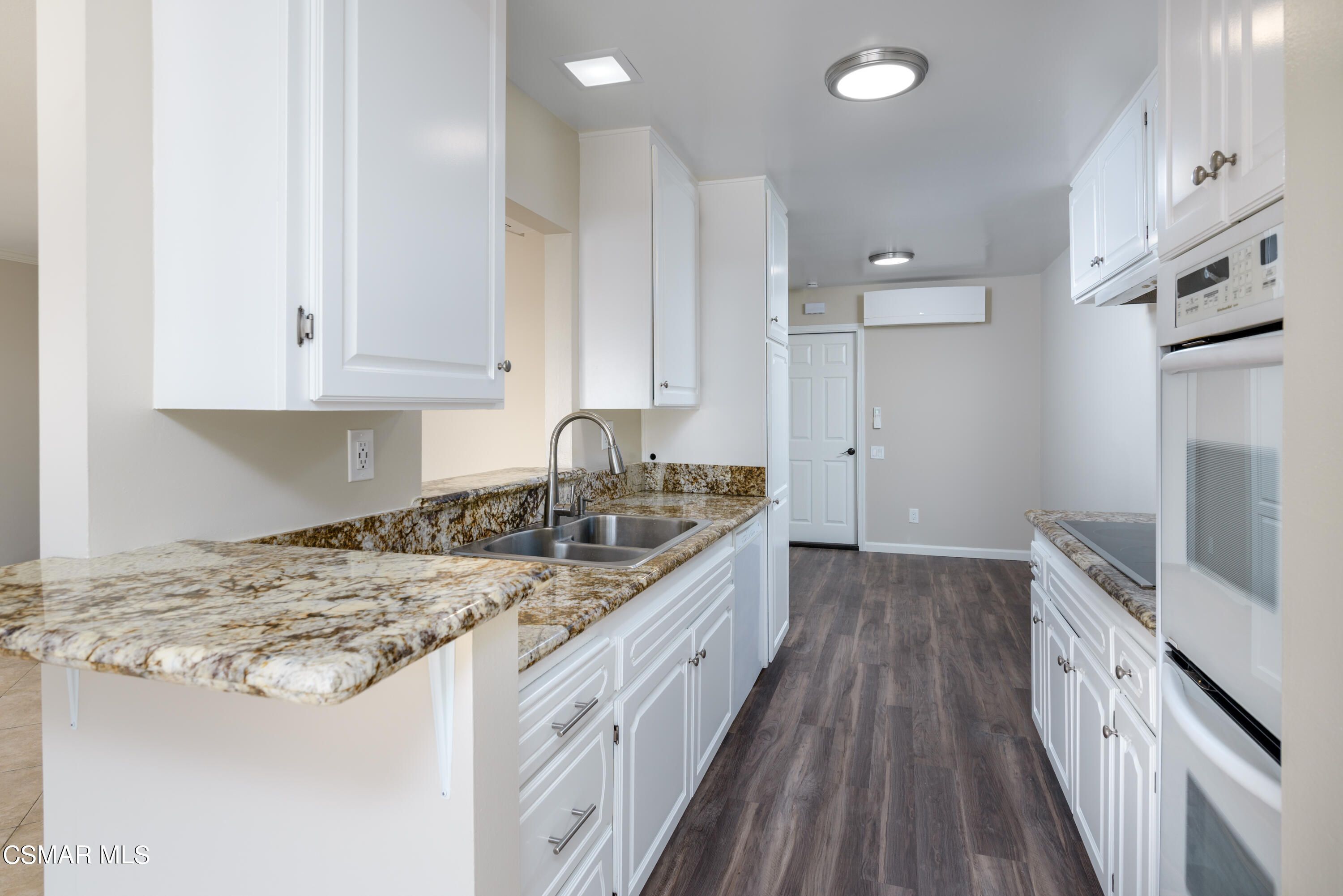 1667 Edgewater Lane Camarillo, CA 93010 - Photo 8 of 32 a kitchen with granite countertop a sink stove and cabinets