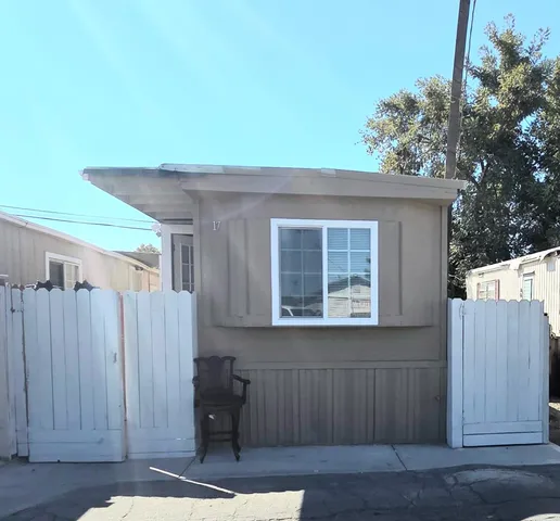 a view of a house with wooden fence