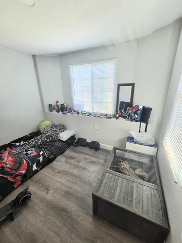 a bedroom with furniture and a window