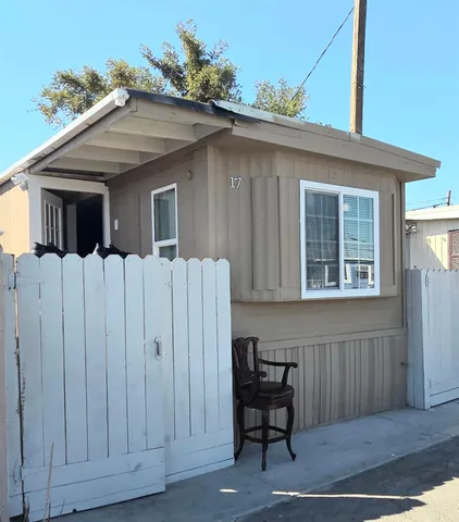 a view of a house with wooden fence