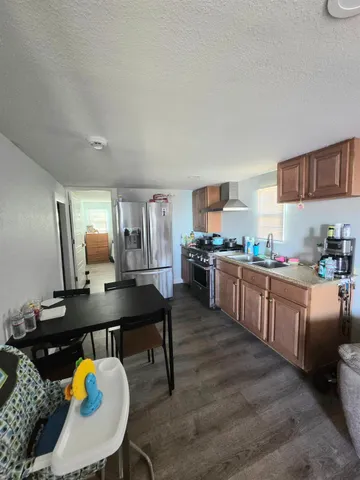 a kitchen with a table chairs sink and cabinets