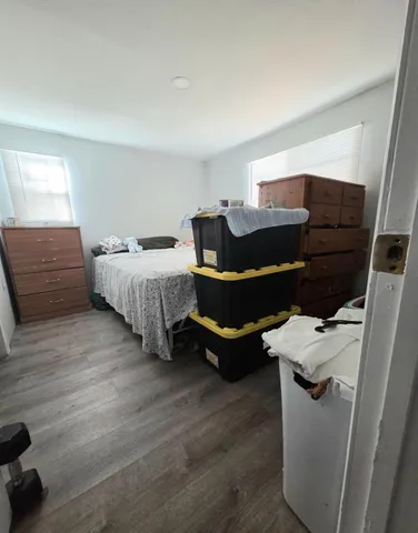 a bedroom with furniture and wooden floor