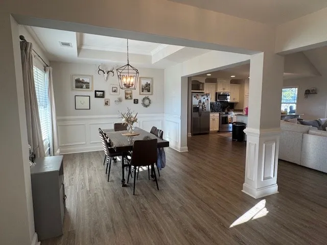 a view of a dining room with furniture and wooden floor