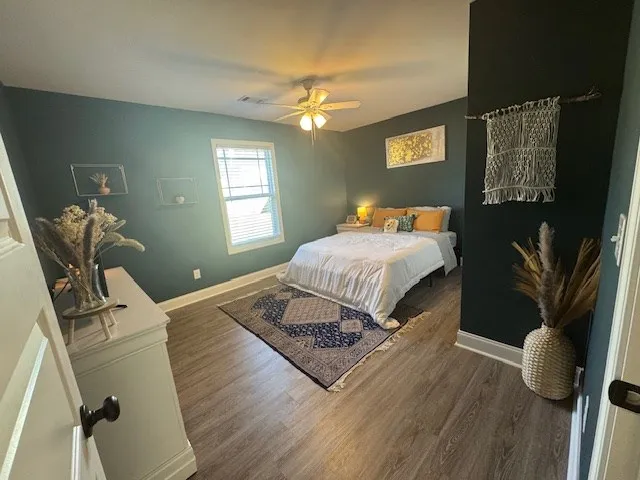 a bedroom with a bed window and couch