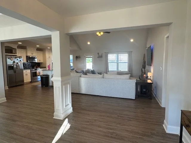 a living room with furniture and a wooden floor